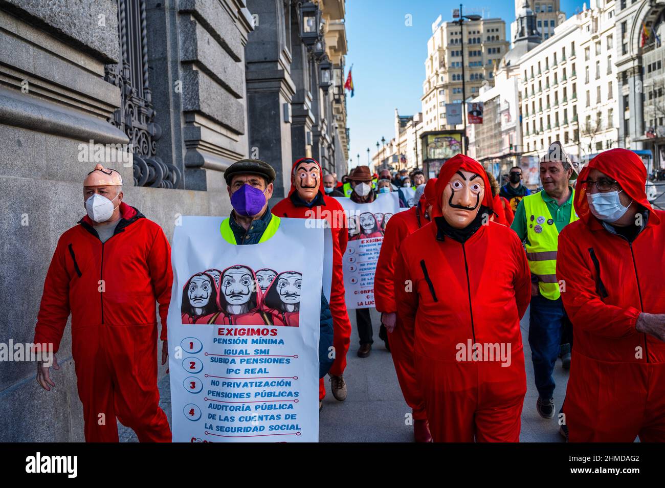 Madrid, Spain. 09th Feb, 2022. Pensioners, some wearing red suits and Dali  masks of the Spanish Netflix series La Casa de Papel (Money Heist) are seen  during a protest carried out from