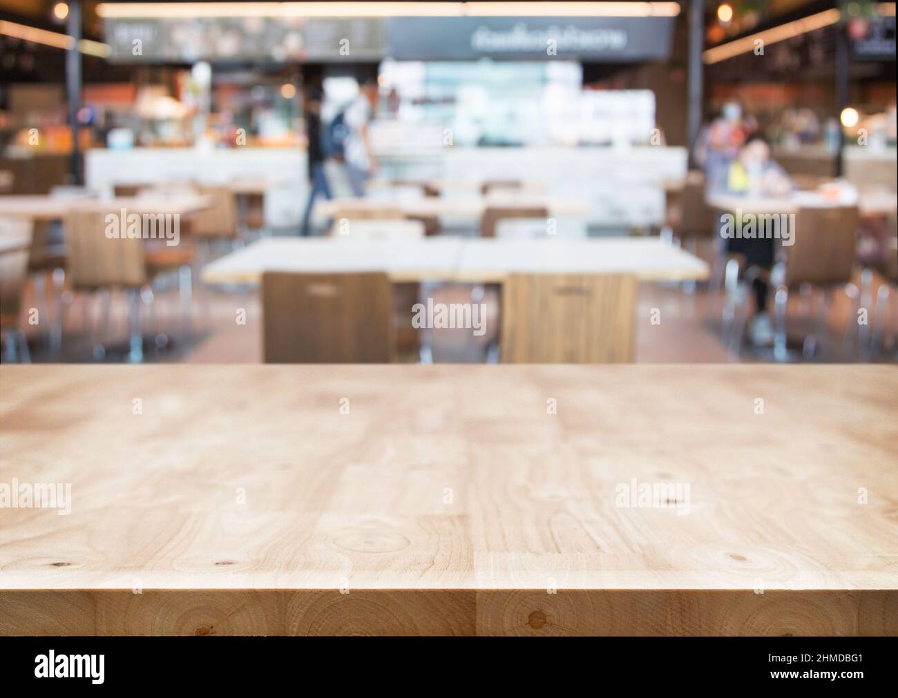 Empty wood table with blur restaurant background ,Mockup for display or montage of nature product, Banner for advertise on online media business prese Stock Photo