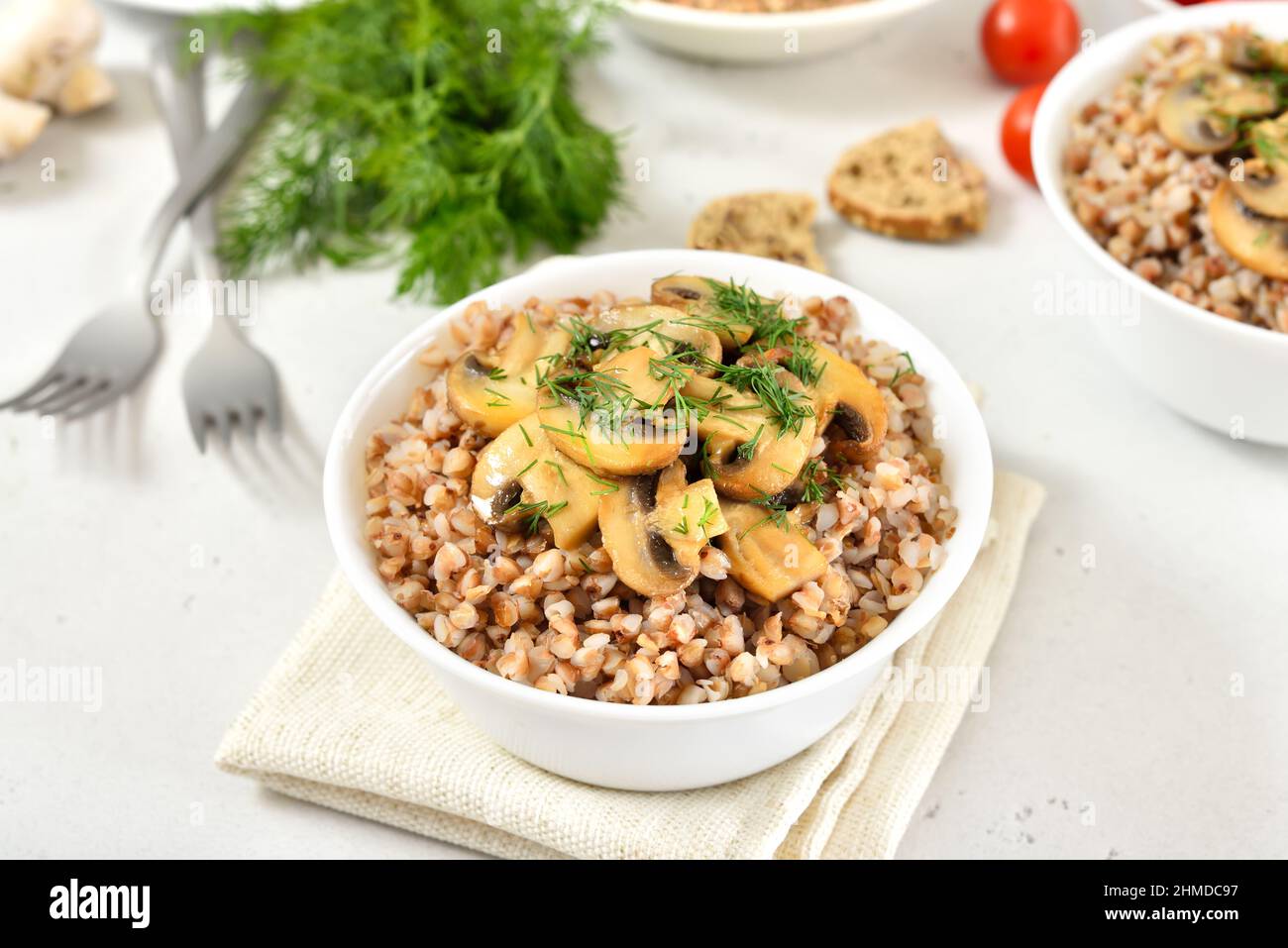 Buckwheat porridge with roasted mushrooms in white bowl. Traditional russian food. Stock Photo