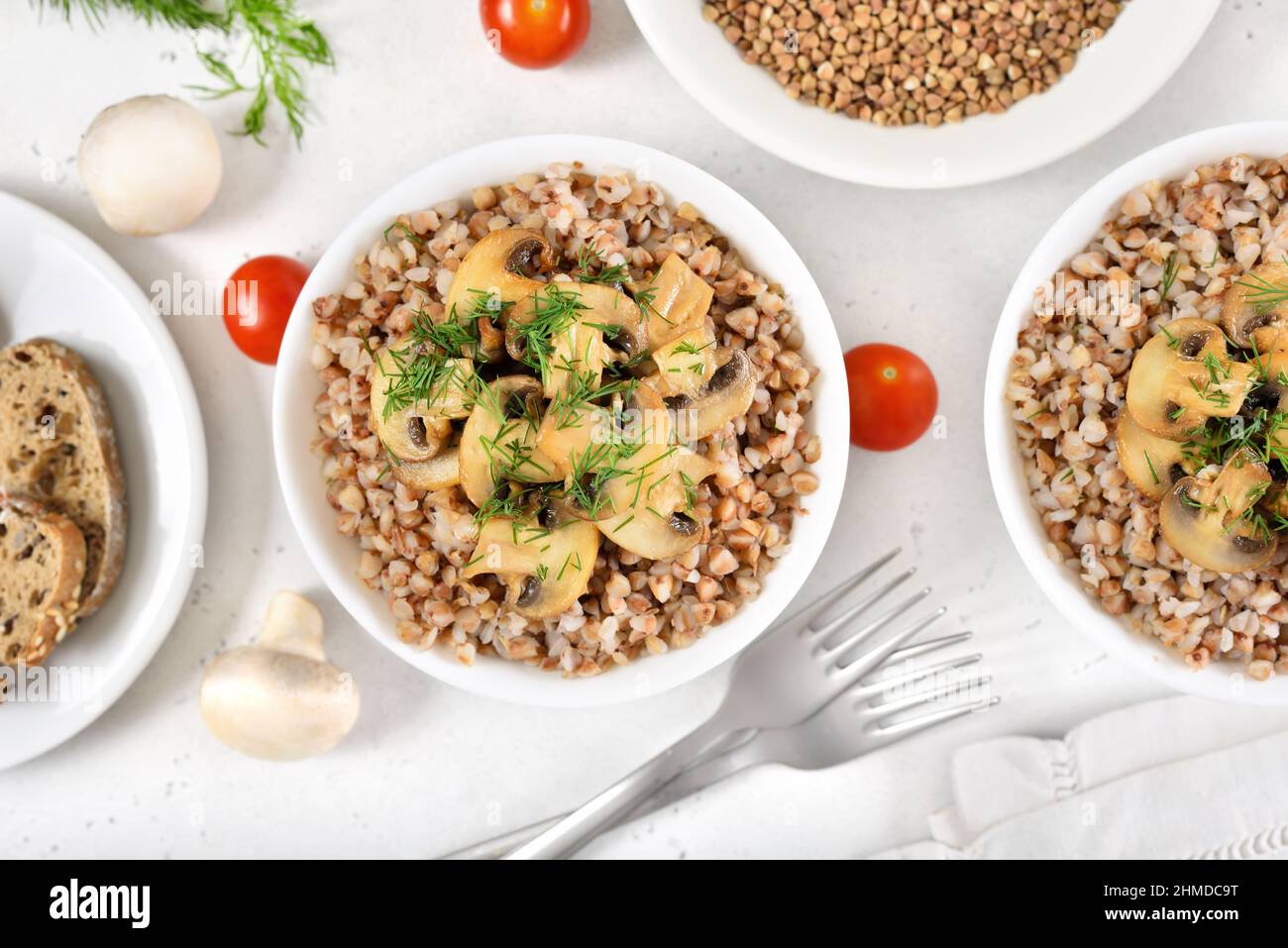 Buckwheat porridge with roasted mushrooms in white bowl. Traditional russian food. Top view, flat lay Stock Photo