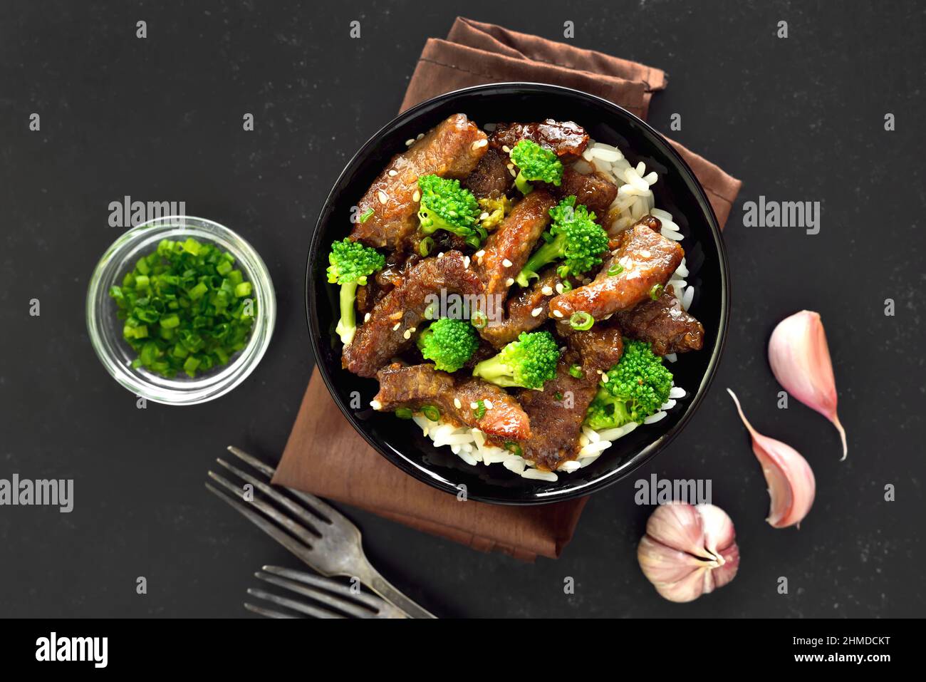 Beef and broccoli stir fry with rice on dark background. Top view, flat lay Stock Photo