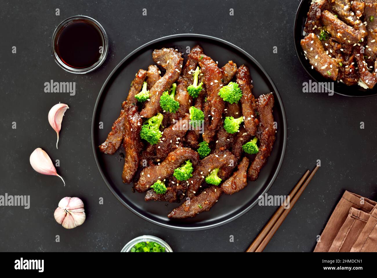 Beef and broccoli stir fry over dark background. Top view, flat lay Stock Photo