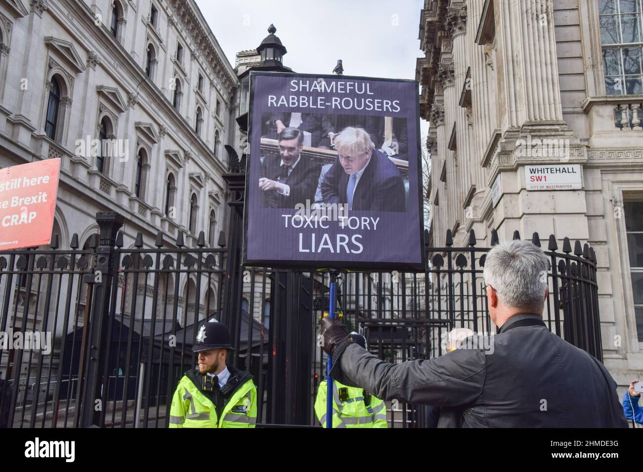 London, UK. 9th February 2022. A protester outside Downing Street. Protesters gathered in Westminster as pressure continues to mount on Boris Johnson over the Partygate scandal. Credit: Vuk Valcic / Alamy Live News Stock Photo