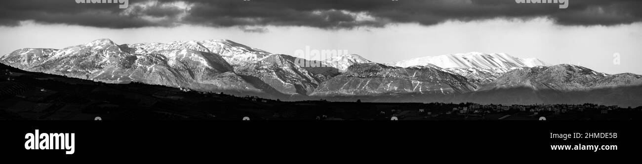 Panoramic view of snow covered mountain range Stock Photo