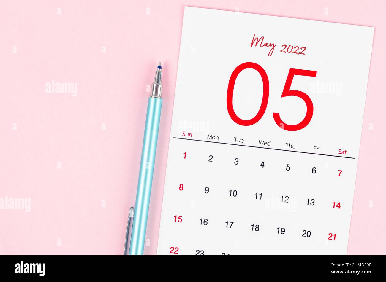 The May 2022 calendar with pen on pink background. Stock Photo