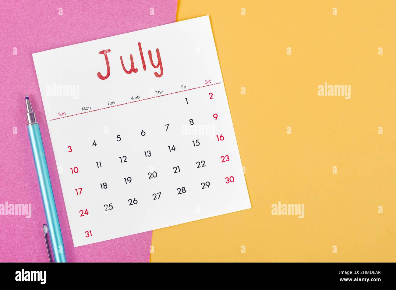 The July 2022 calendar  with pen on multicolored background. Stock Photo