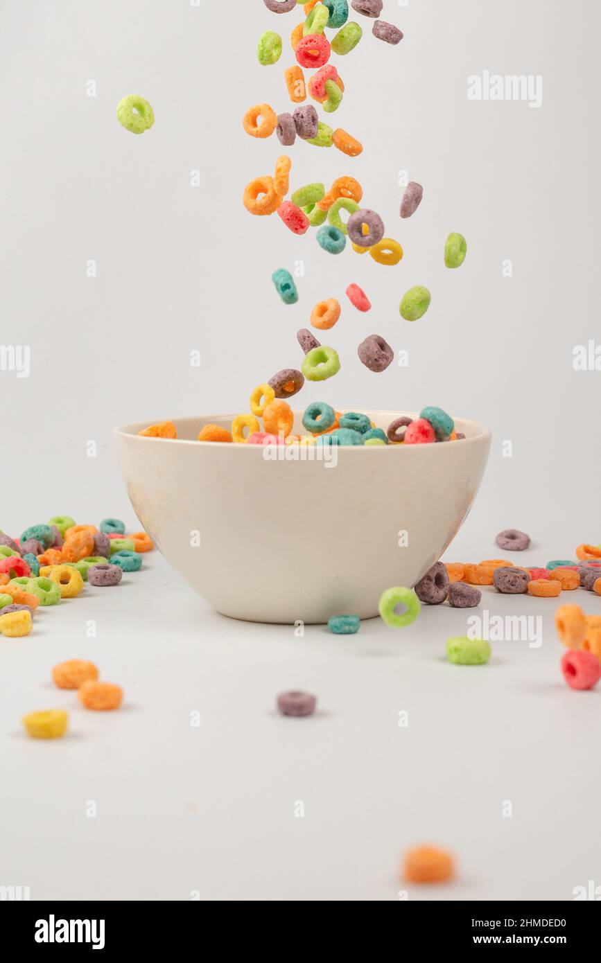 Colorful cereal box for morning breakfast. Corn flakes falling to the