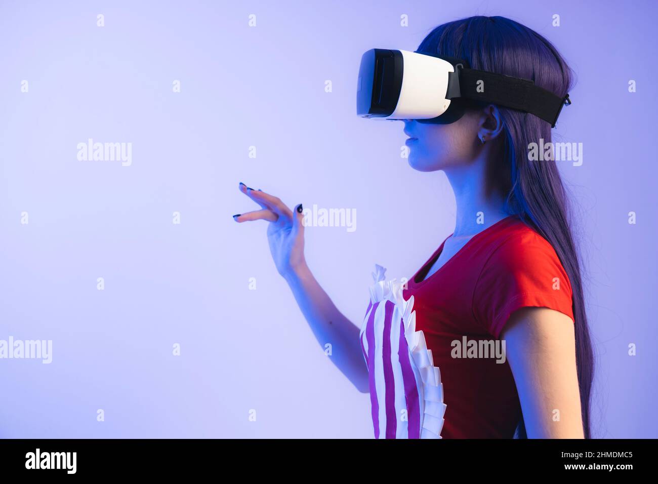 Waitress in apron using VR headset goggles and virtual interface with hand gestures. High quality photo Stock Photo