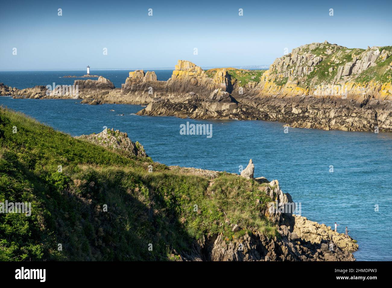 Distant view of lighthouse with cliff on sea, Brittany, France Stock Photo