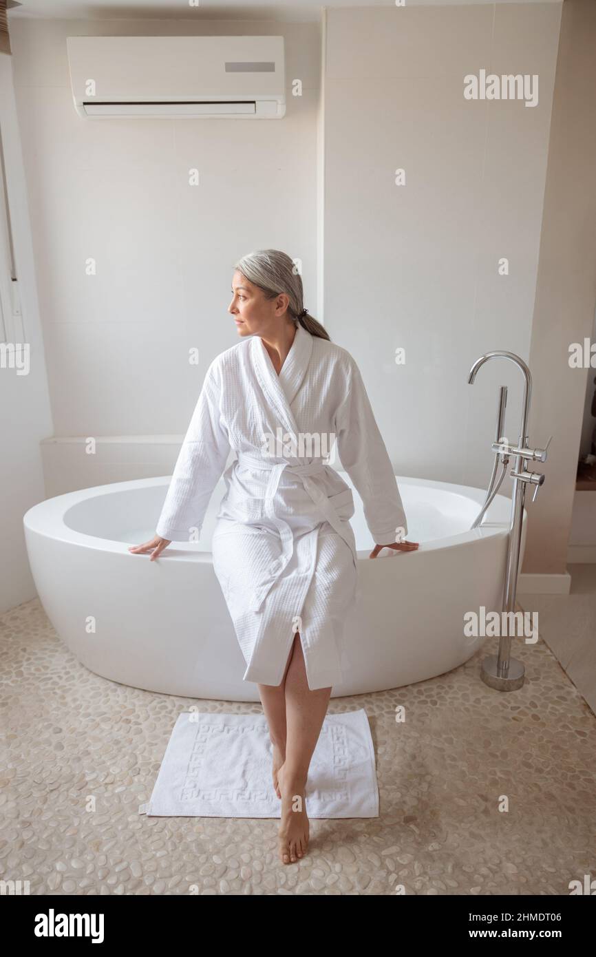 Beautiful lady getting ready to take bath Stock Photo Alamy