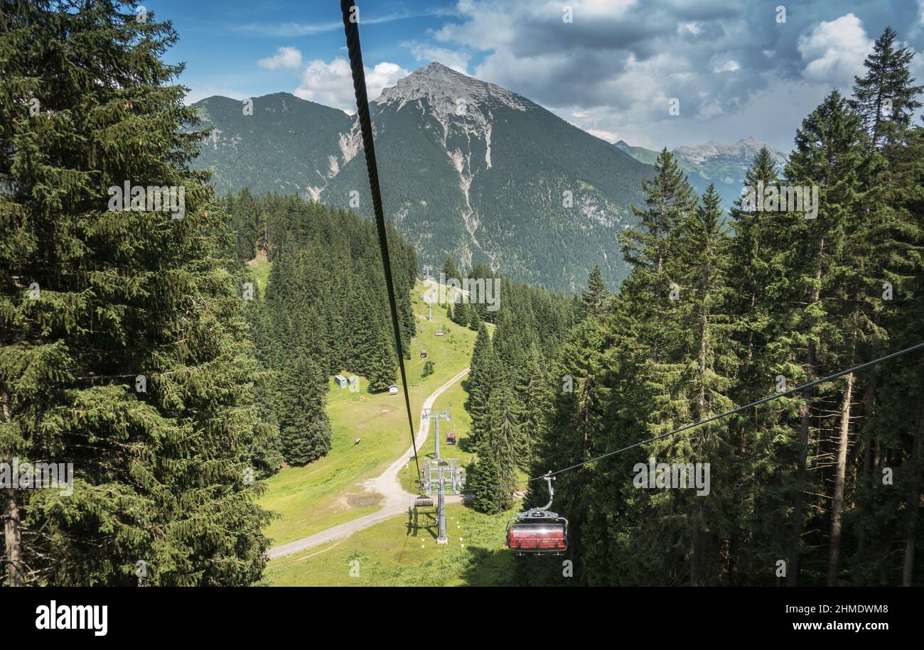 Overhead cable car in forest, Austria Stock Photo