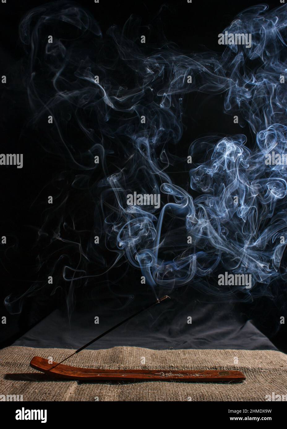 indian incense stick with smoke on black background indoor closeup Stock  Photo - Alamy