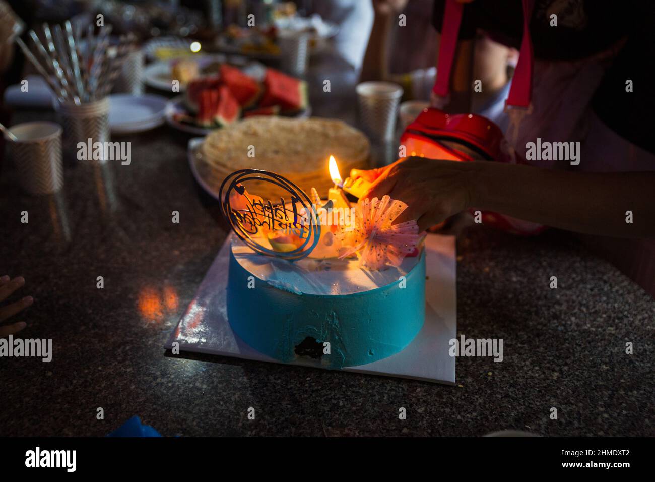 Birthday cake, presents, hats over light grey Stock Photo