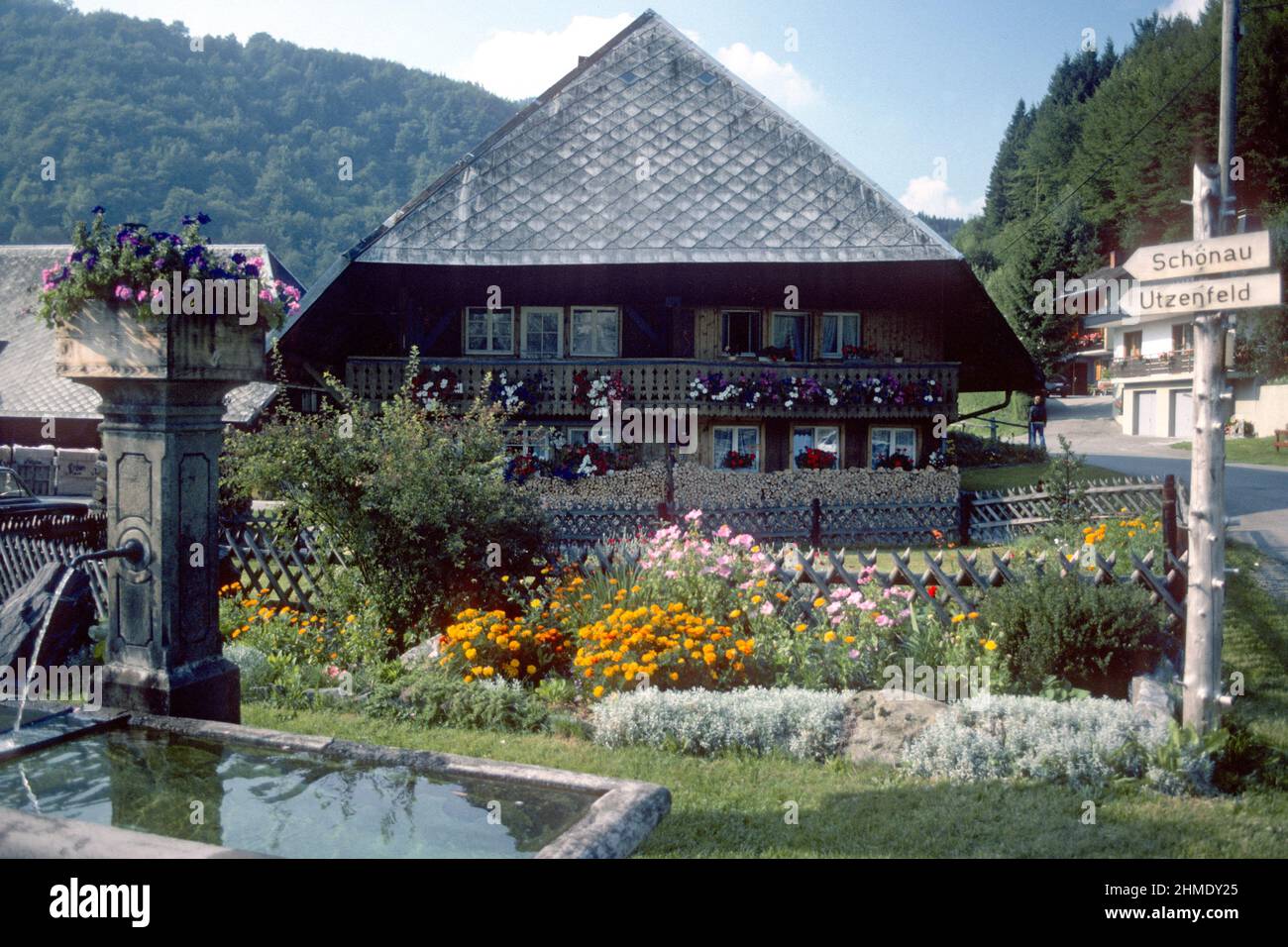 Traditional house and fountain in village centre in 1981, Geschwend, Baden-Württemberg, Germany Stock Photo