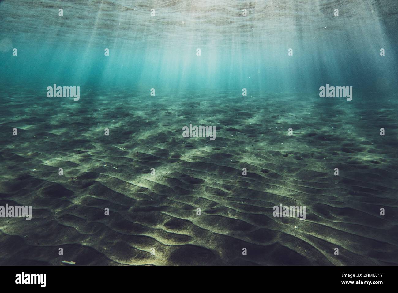Sunlight on rippled sand at bottom of ocean floor Stock Photo
