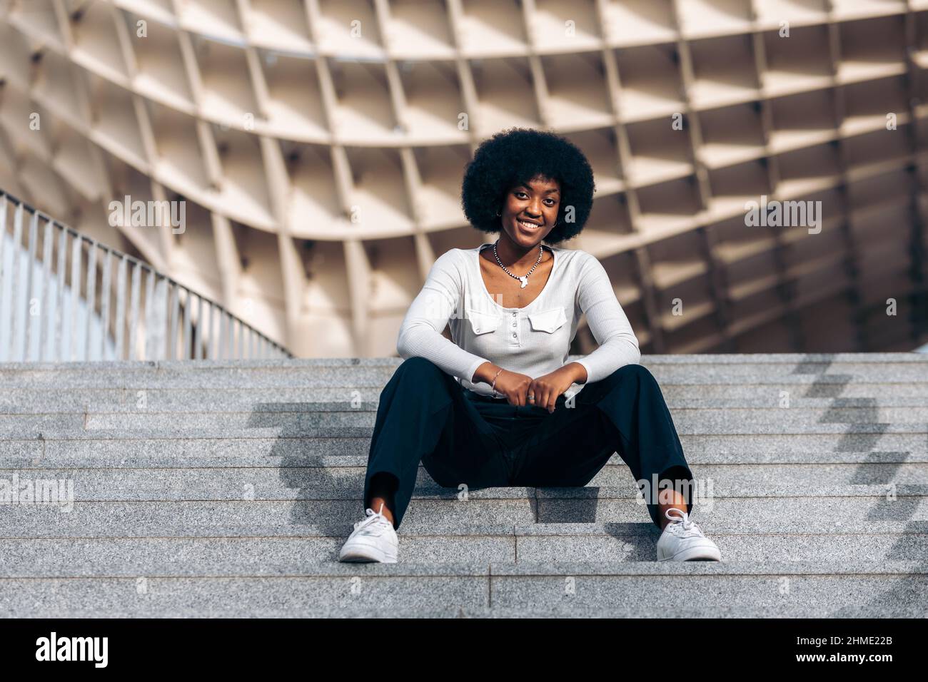 Black woman sitting hi-res stock photography and images - Alamy