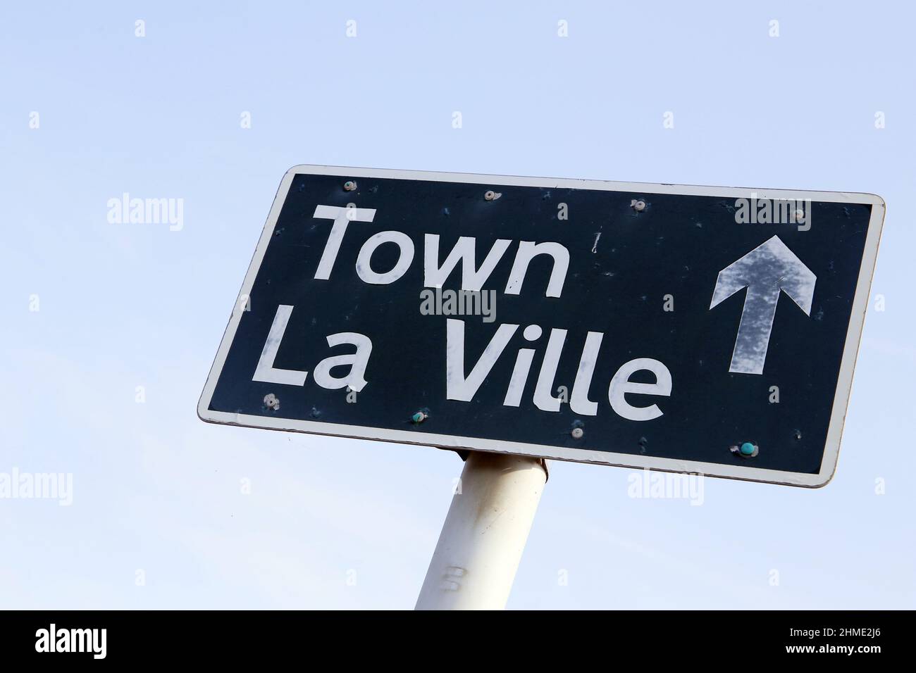 Direction sign to Town in English and French, Alderney, Channel Islands Stock Photo