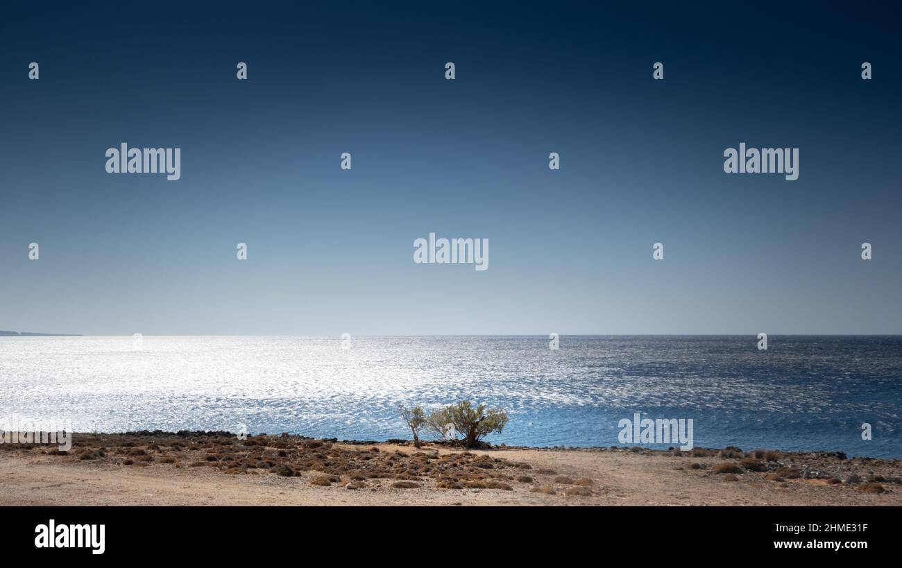 Beautiful landscaped scenery with sea against clear sky Stock Photo