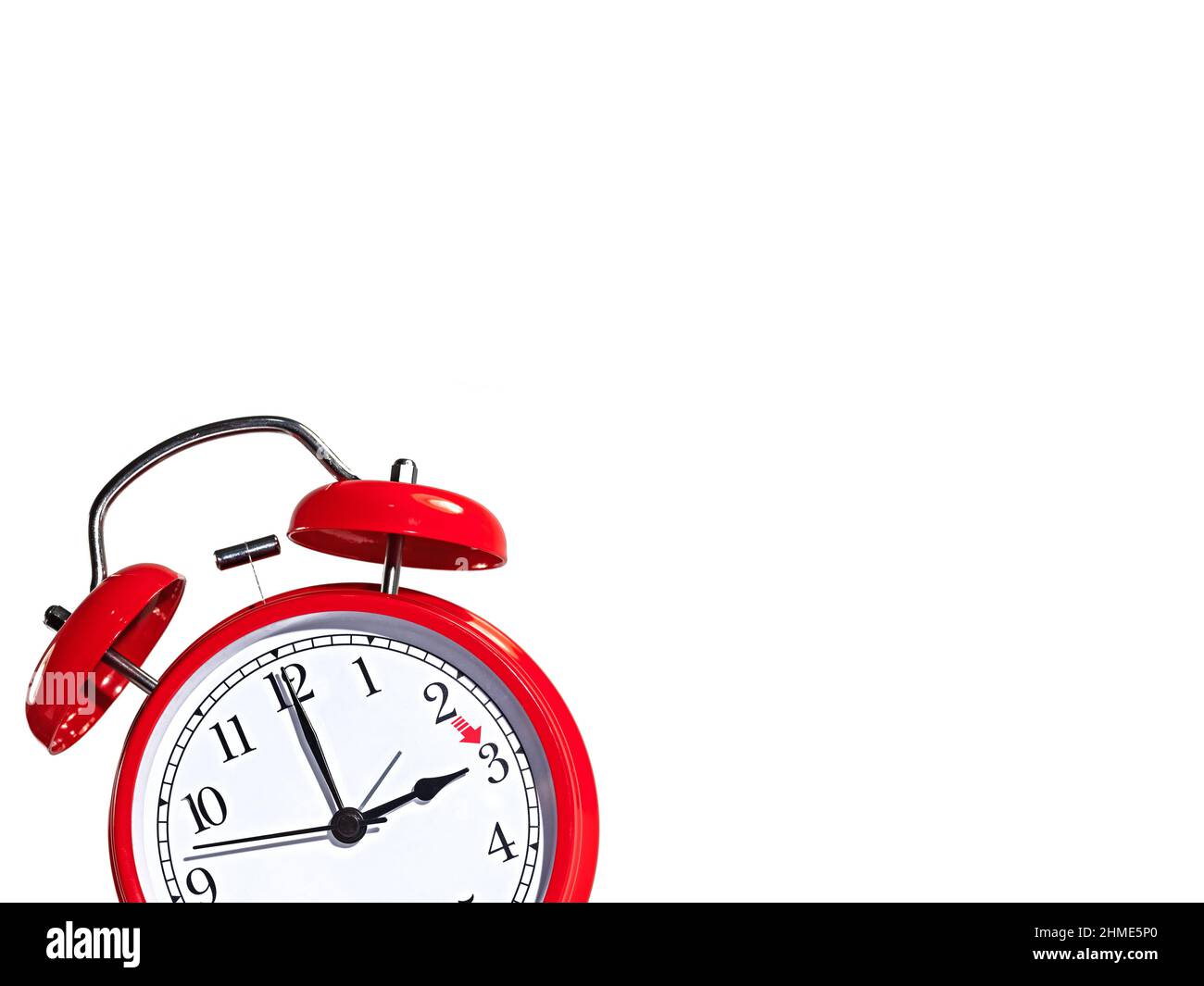 Red alarm clock against white background, daylight saving time