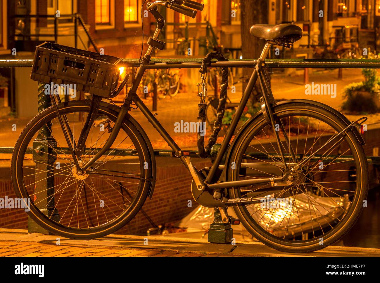 Netherlands. Night Amsterdam. Bicycle with a luggage basket is parked