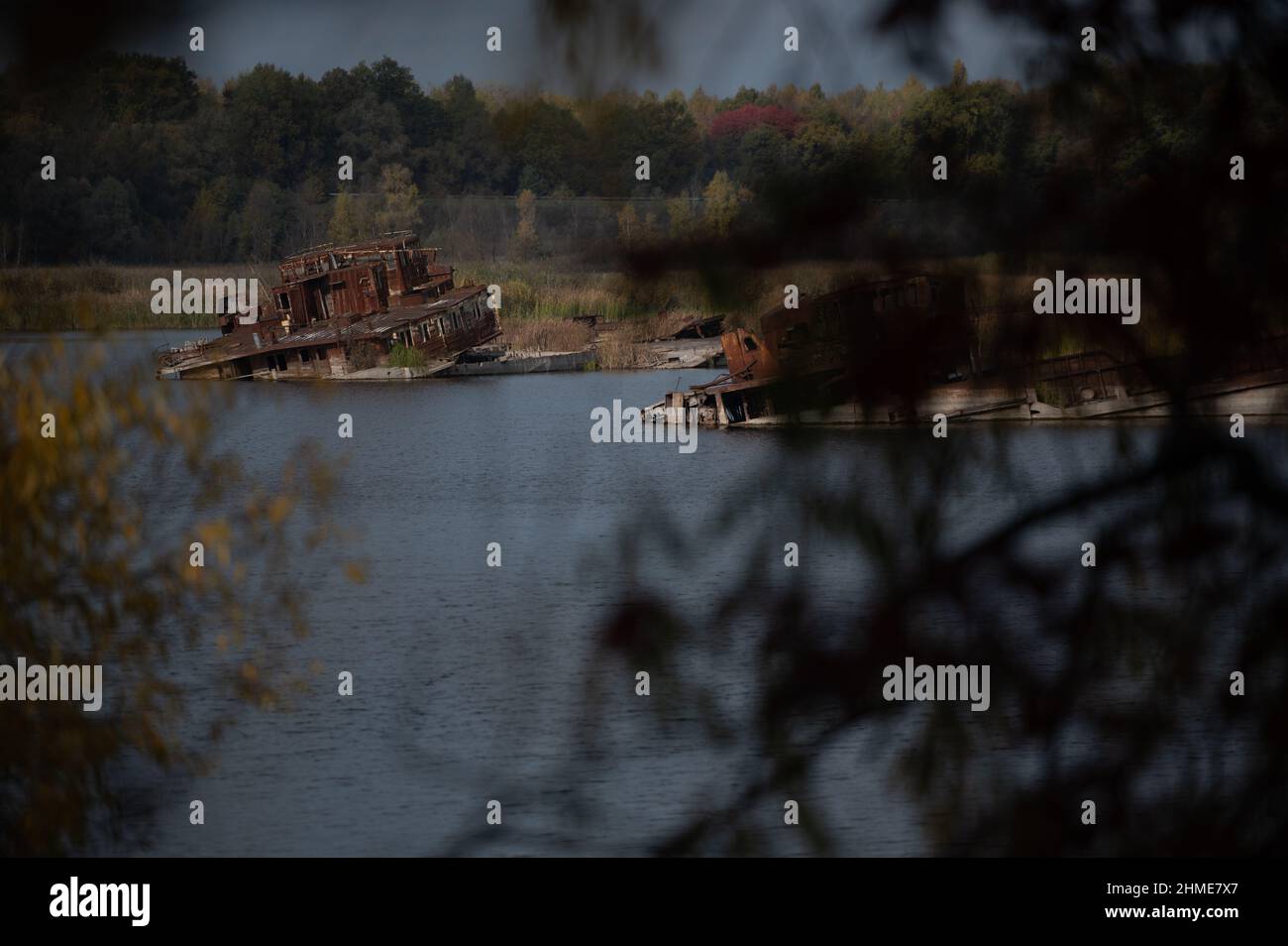 Sunken boats lie in the Chernobyl Ship Yard on the Pripyat River, near the Chernobyl Nuclear Power Plant. Stock Photo