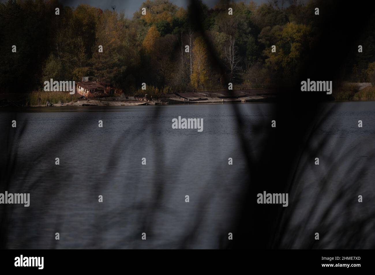 Sunken boats lie in the Chernobyl Ship Yard on the Pripyat River, near the Chernobyl Nuclear Power Plant. Stock Photo