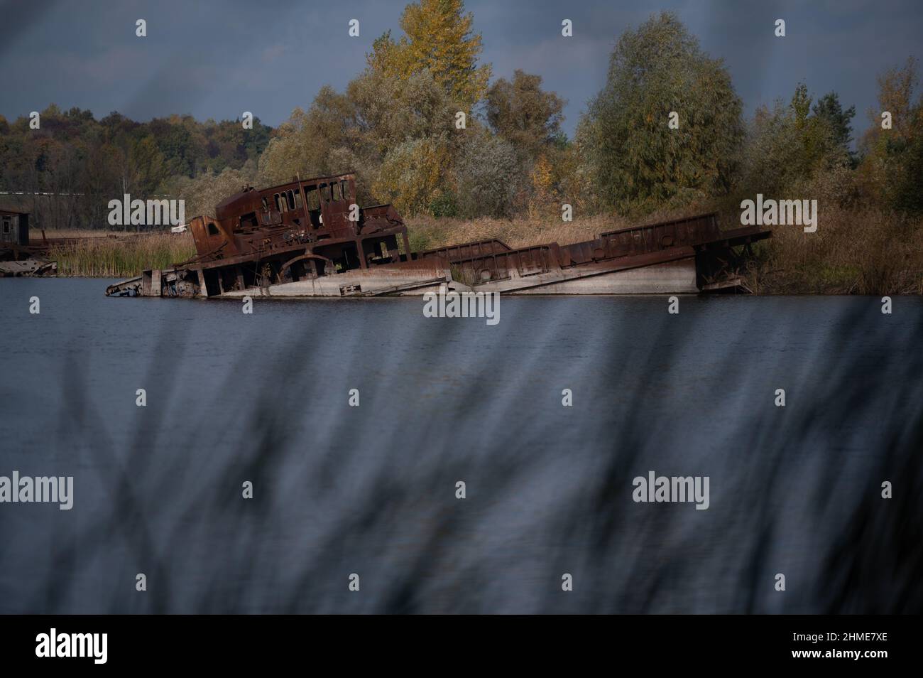 Sunken boats lie in the Chernobyl Ship Yard on the Pripyat River, near the Chernobyl Nuclear Power Plant. Stock Photo