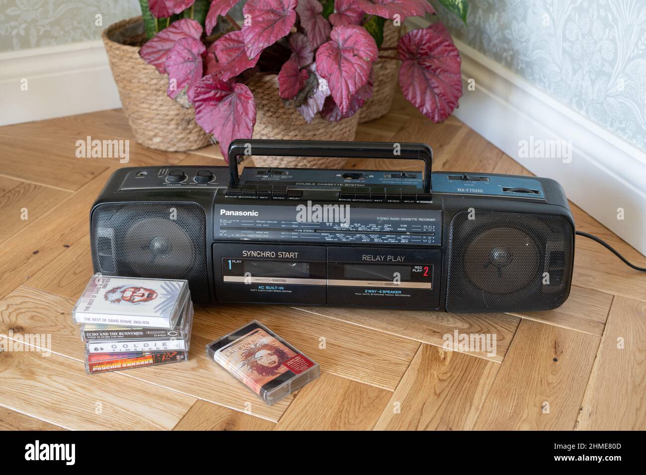 New Generation Nostalgia. Retro Resurgence. Young people discovering old music, dusting off the ghetto blaster to hear parents' cassettes. Stock Photo
