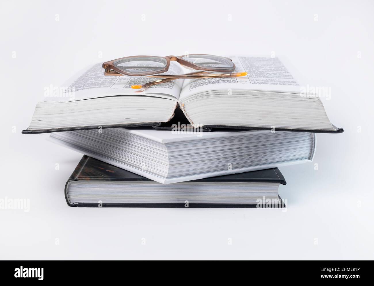 Eyeglasses at books stack. Education, reading hobby, preparing for