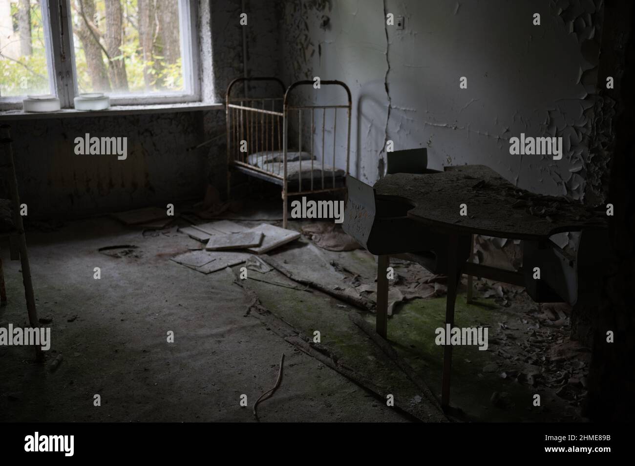 Abandoned beds in a nursery in a decaying hospital in Pripyat, Ukraine near the Chernobyl Nuclear Power Plant. Stock Photo