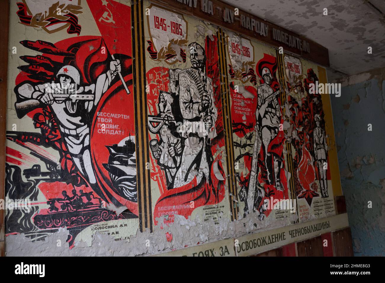 Soviet propaganda posters still hanging in a derelict school near the Chernobyl Nuclear Power Plant in Pripyat, Ukraine. Stock Photo