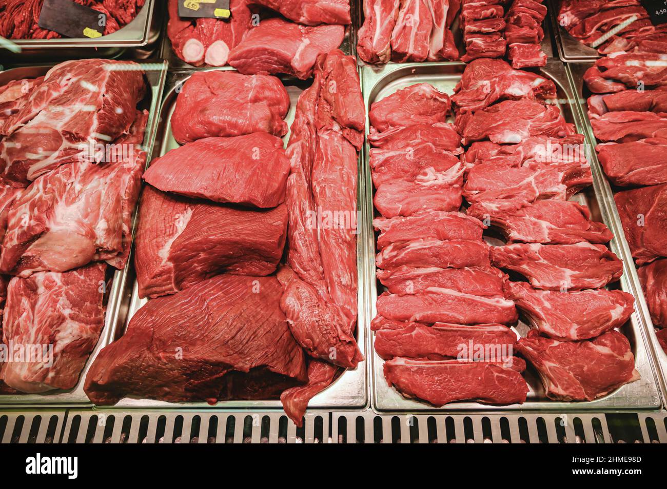 Raw beef and pork for cooking on a shelf in a supermarket. Raw red meat ...