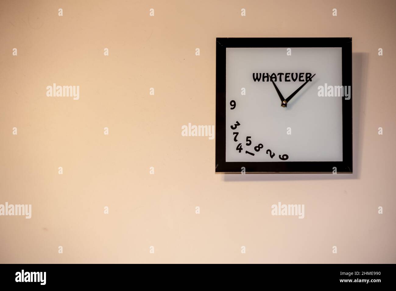 Time Without Numbers a square clock without numbers hangs on the wall. A watch with an ...