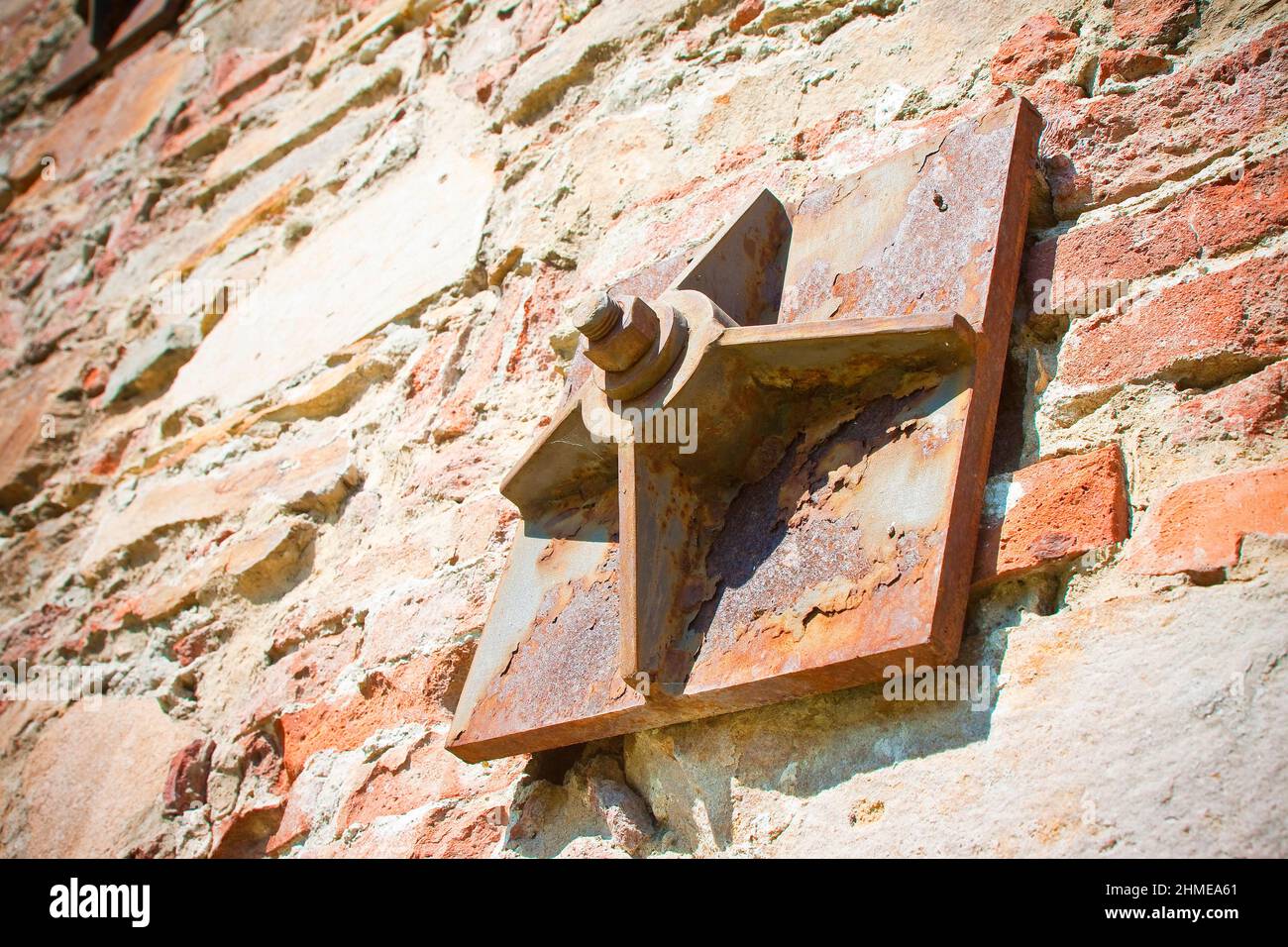 Old brick wall reinforced with metal plates Stock Photo