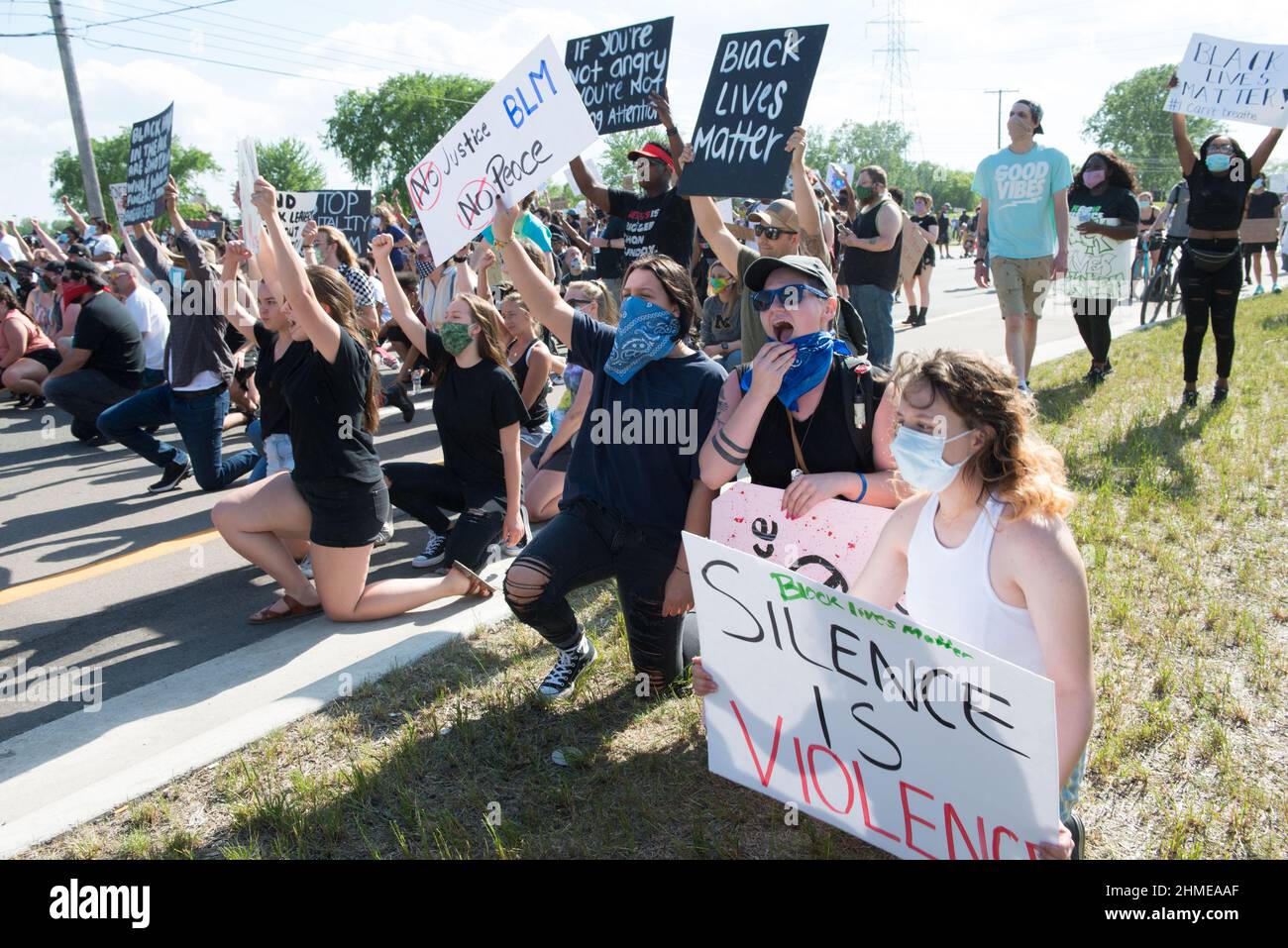 Protest marchers take a knee on Hall road in Sterling Heights, Michigan during the Black Lives Matter protest march. Stock Photo