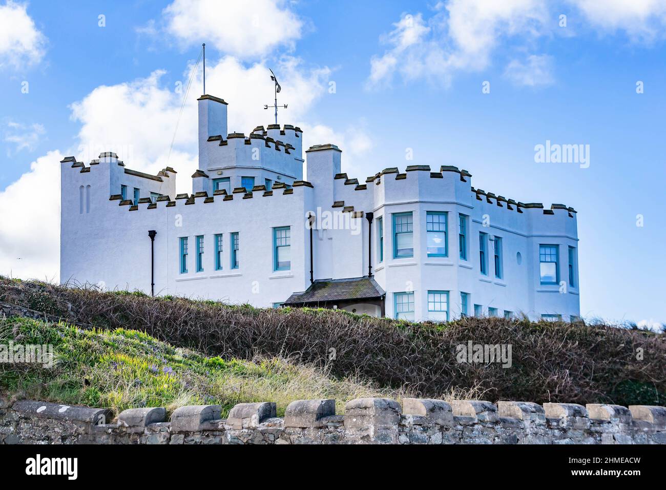 Surf Point (Sausage Point), a romantic beach front castellated seaside 'folly' style holiday home in Rhosneigr, Anglesey, North Wales, UK Stock Photo