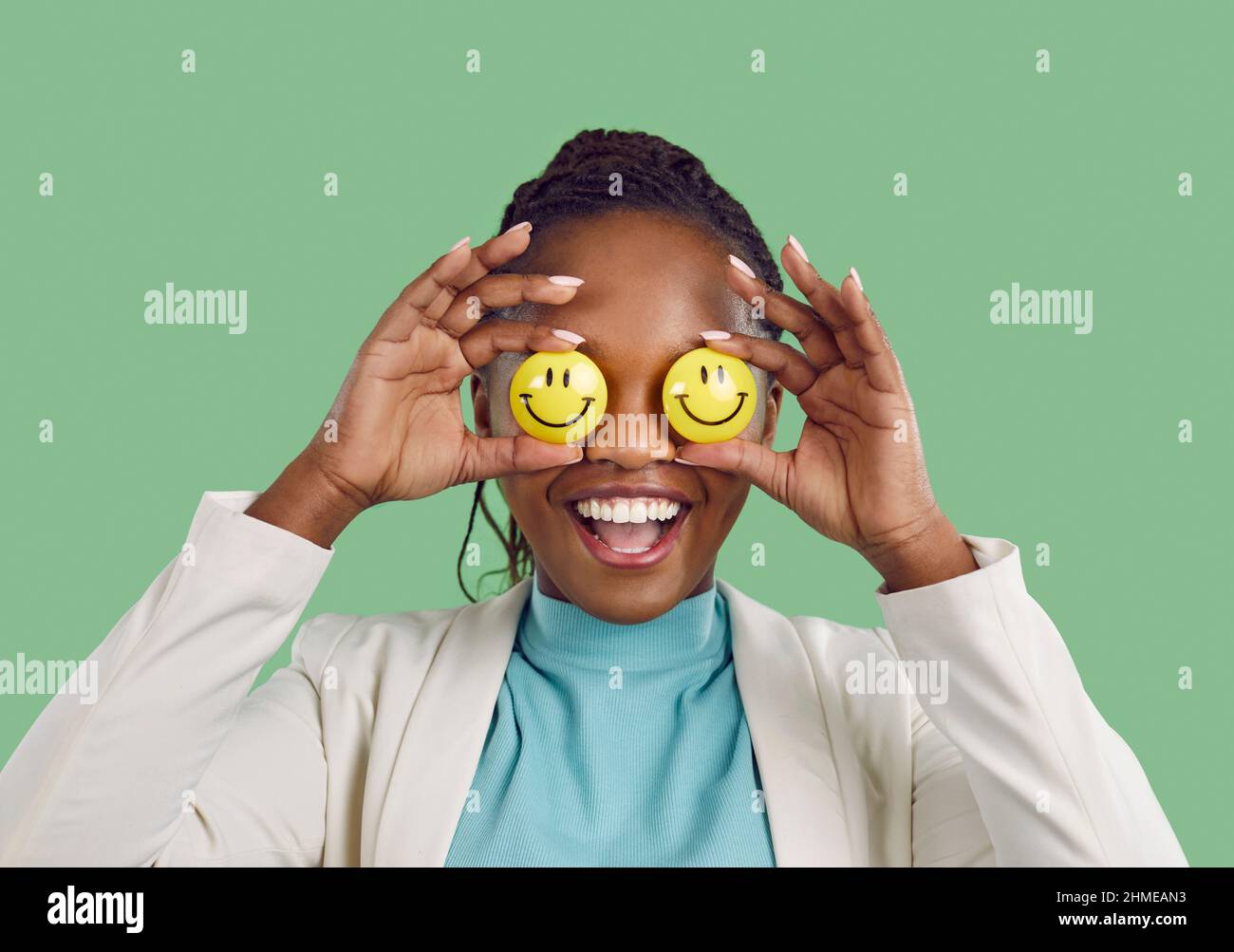Studio portrait of a happy positive optimistic African American lady with emoji eyes Stock Photo