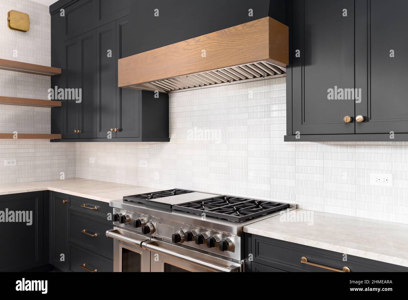 A luxury kitchen with black granite counter top, tiled