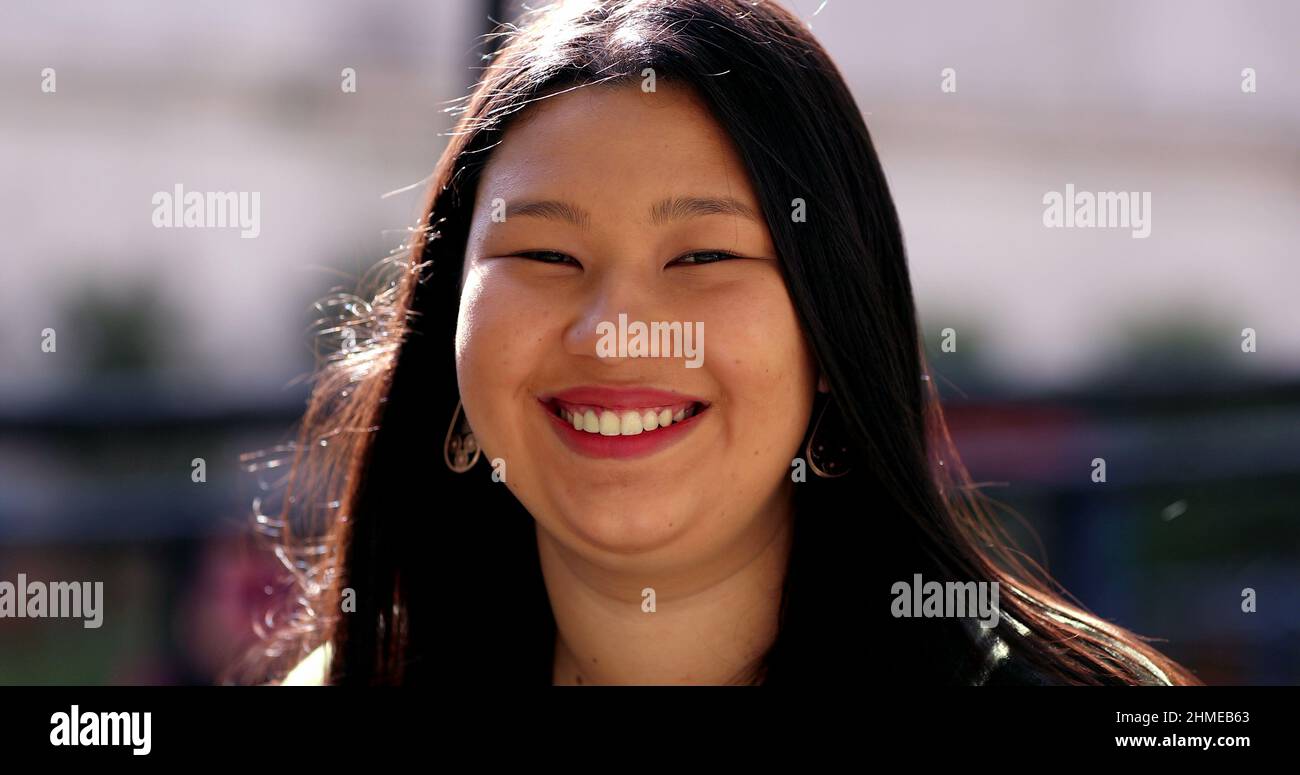 Asian young woman, larger sizer Japanese descent lady smiling outdoors