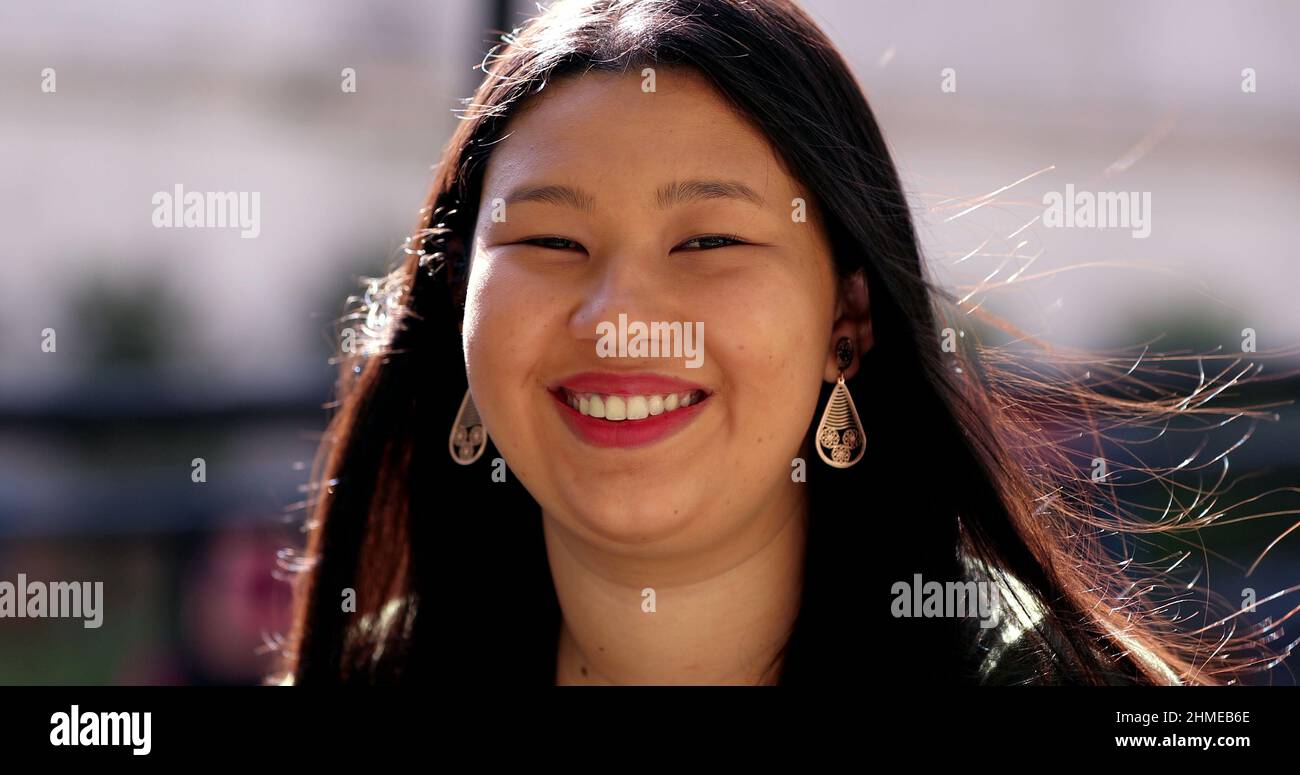 Asian young woman, larger sizer Japanese descent lady smiling outdoors