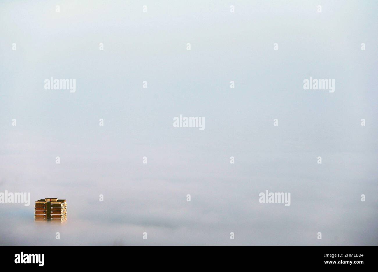 High rise flats and apartments surround by low lying clouds in Belfast, Northern Ireland. Stock Photo