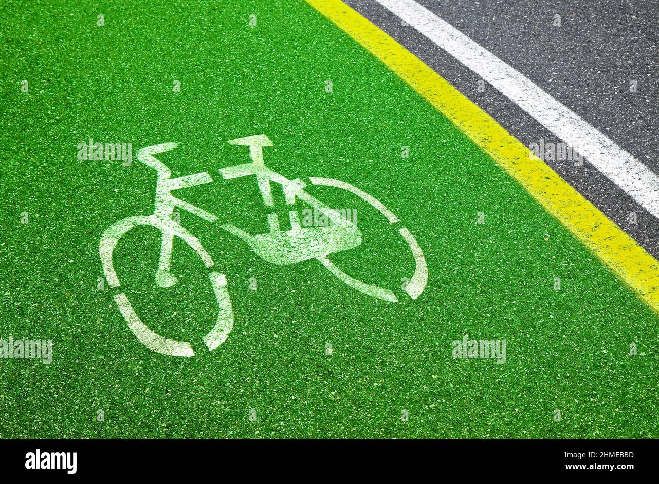 Bicycle Lane - bicycle silhouette drawn on green asphalt Stock Photo