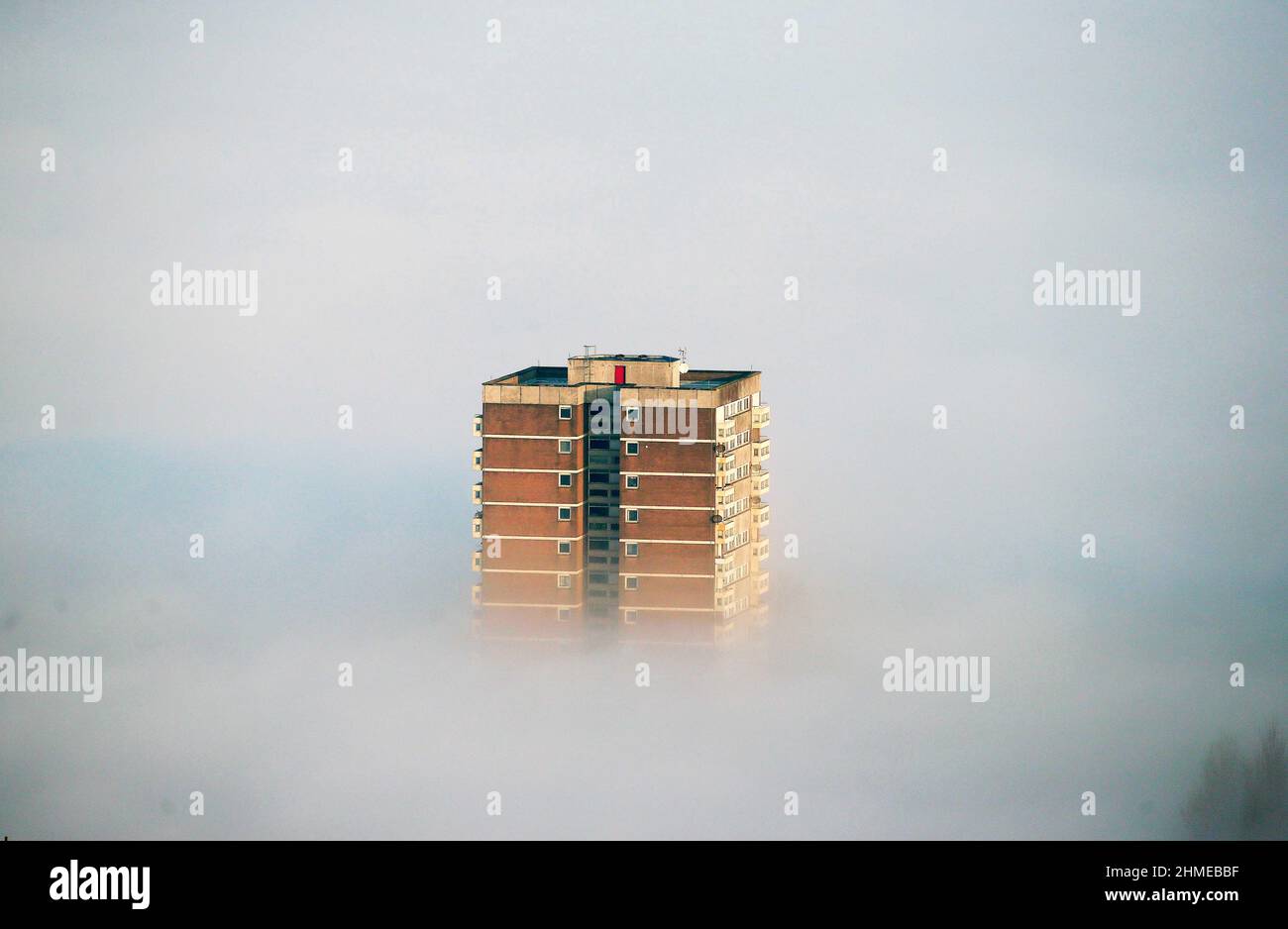 High rise flats and apartments surround by low lying clouds in Belfast, Northern Ireland. Stock Photo