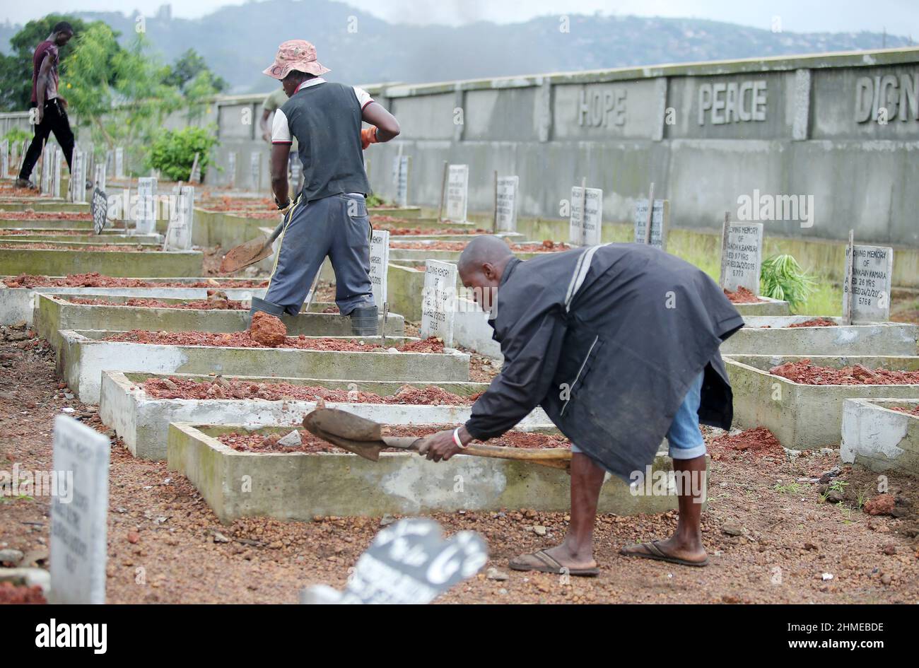 A cemetery is tended to in Sierra Leone's capital Freetown, where victims of the 2015 Ebola crisis were buried. Stock Photo