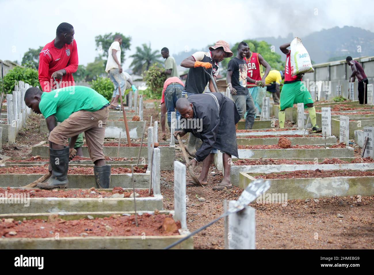 A cemetery is tended to in Sierra Leone's capital Freetown, where victims of the 2015 Ebola crisis were buried. Stock Photo