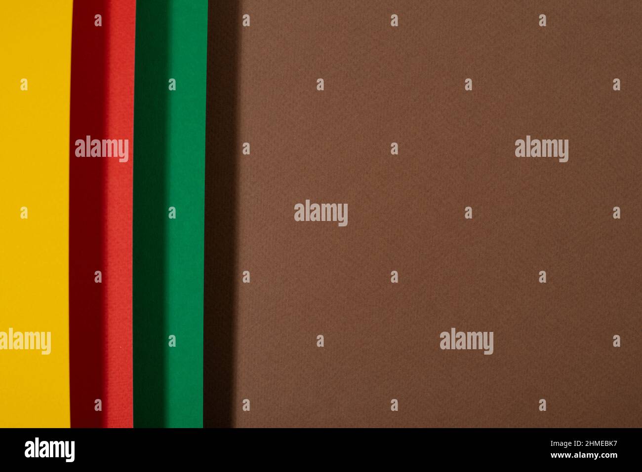 Black history month colors background. Red, green and yellow paper cut abstract composition. Stock Photo