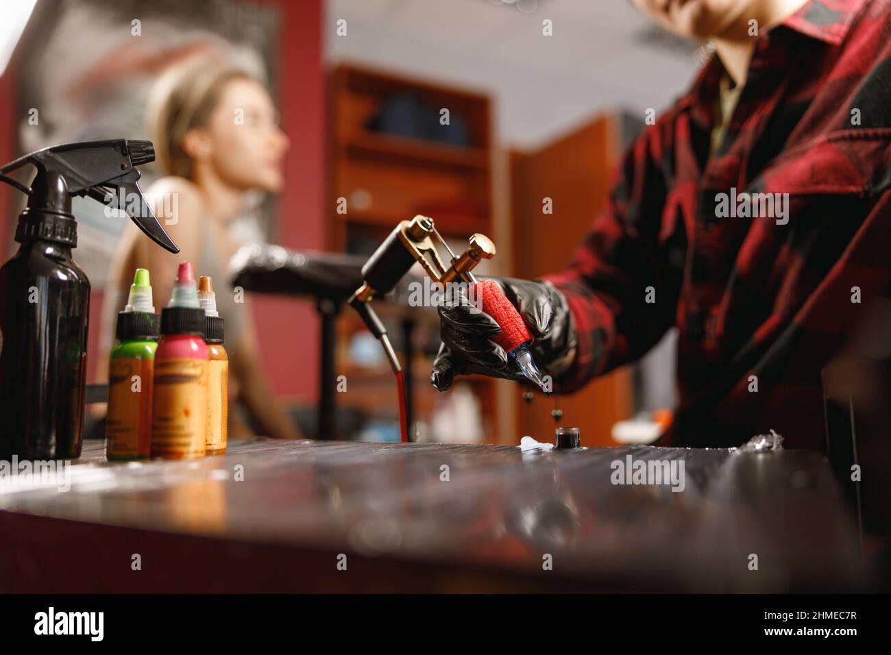 Female hands of tattoo artist holding tattoo machine Stock Photo Alamy