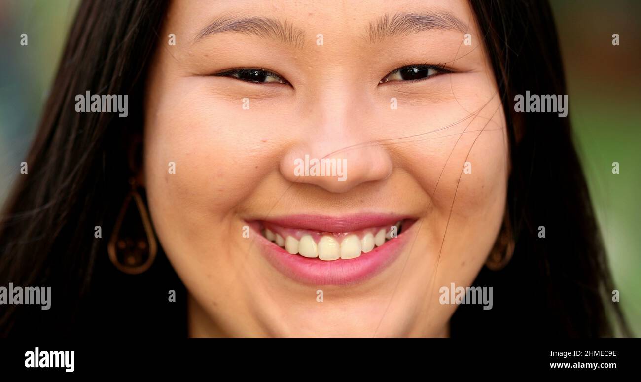 Happy Asian large young woman smiling at camera closeup portrait face