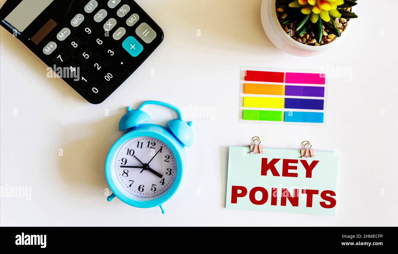 Sticker with the text KEY POINTS, next to a calculator, a cactus clock