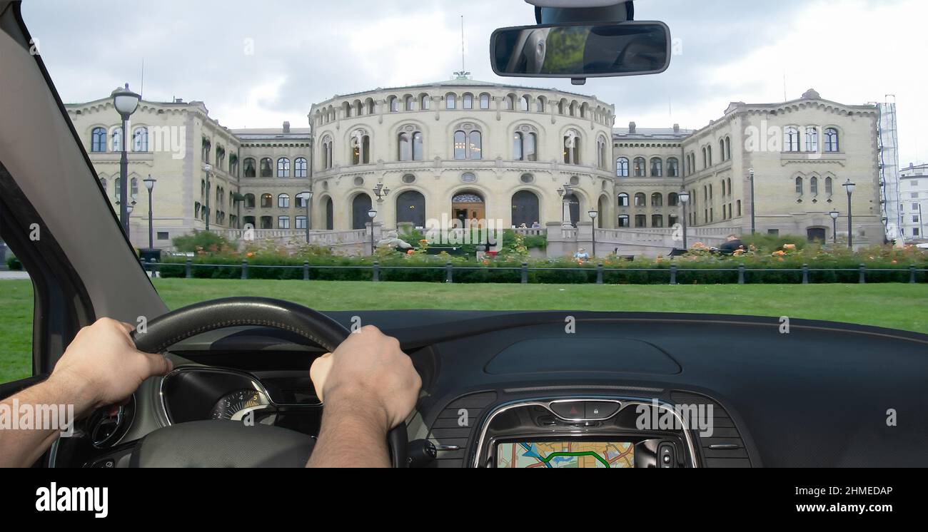 Driving a car towards the facade of the Norwegian Parliament in Oslo, Norway Stock Photo